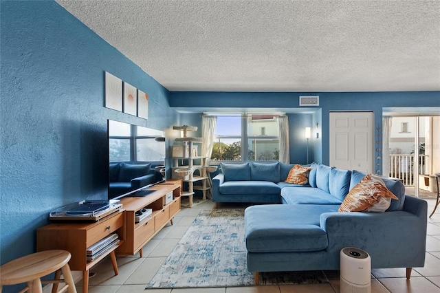 living room featuring light tile patterned floors and a textured ceiling