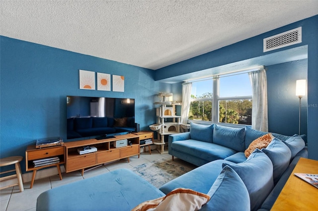 living room with light tile patterned floors and a textured ceiling