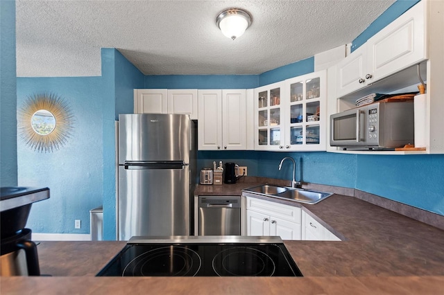 kitchen featuring stainless steel appliances, sink, and white cabinets