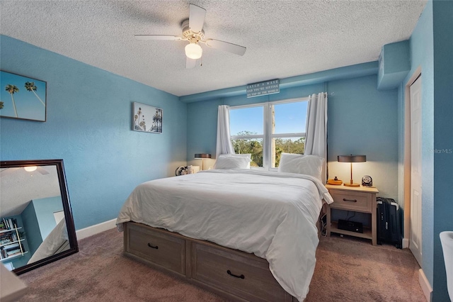 carpeted bedroom featuring ceiling fan and a textured ceiling