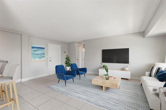 3315 58th Ave S Unit 314, Saint Petersburg, FL 33712 - living area with a textured ceiling, light tile patterned floors, and baseboards