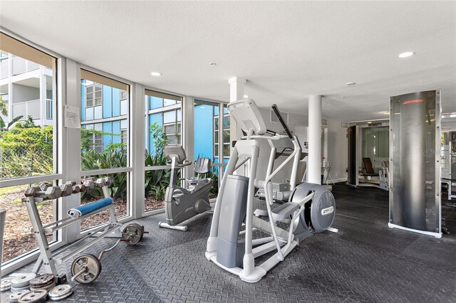 3315 58th Ave S Unit 314, Saint Petersburg, FL 33712 - workout area with a wall of windows, a textured ceiling, and recessed lighting