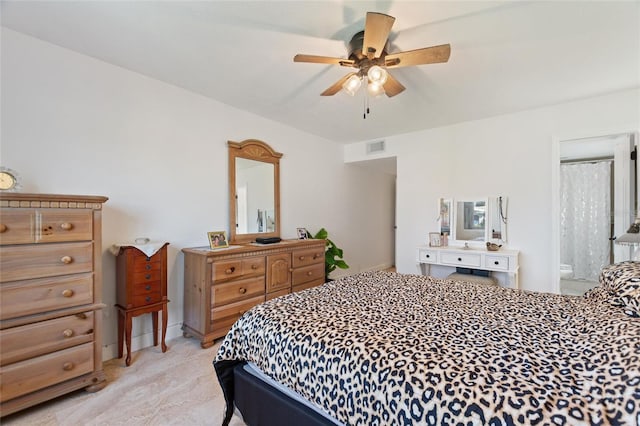 bedroom featuring ensuite bath and ceiling fan