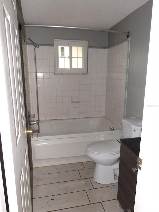 full bathroom with bathtub / shower combination, vanity, and toilet