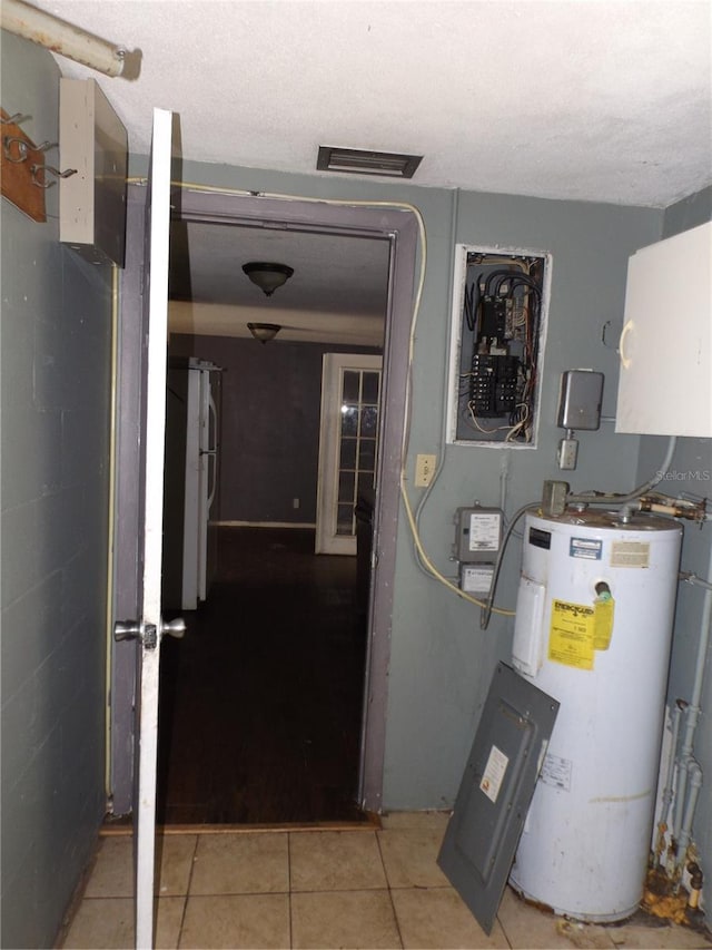 utilities with water heater and visible vents