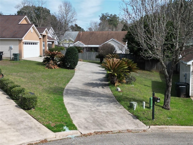 view of front of home with a front yard and a garage