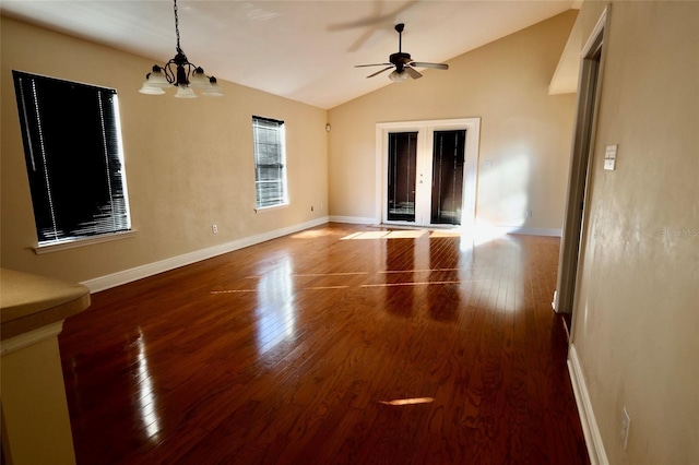 unfurnished room featuring ceiling fan with notable chandelier, lofted ceiling, and wood-type flooring