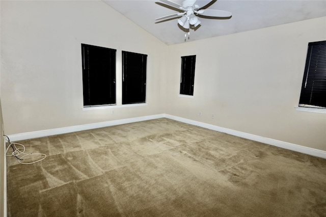 empty room featuring light carpet, lofted ceiling, and ceiling fan