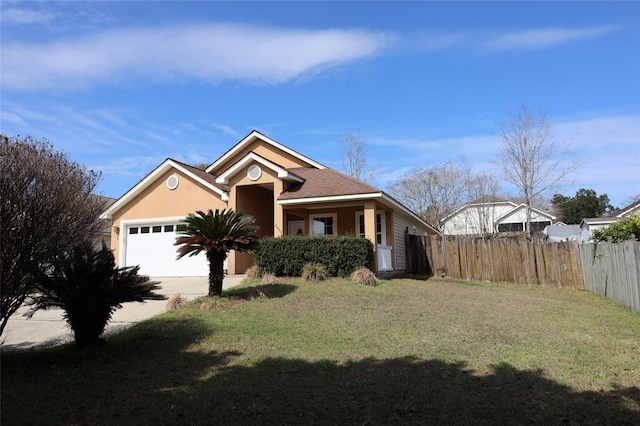 view of front of property featuring a front yard and a garage