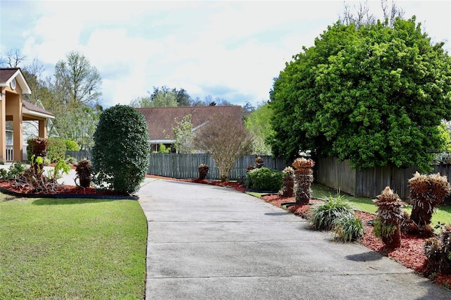 exterior space featuring driveway and fence