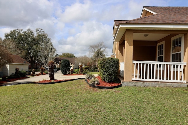 view of yard featuring covered porch