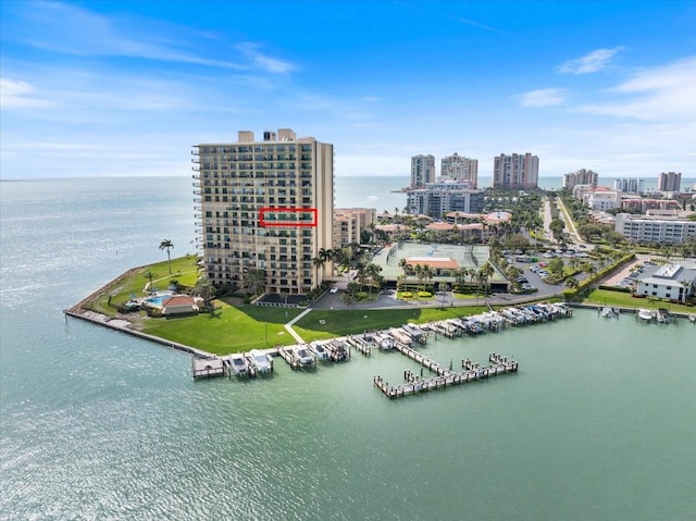 birds eye view of property featuring a view of city and a water view