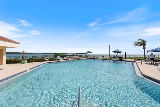 community pool featuring a patio and fence