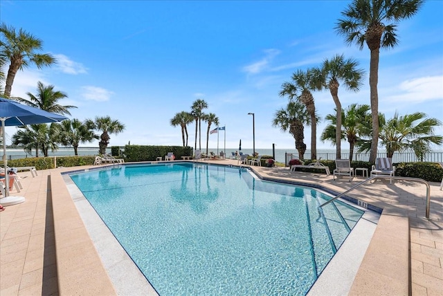 community pool featuring a patio area and fence