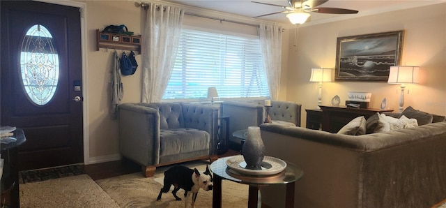 living room featuring ornamental molding and ceiling fan