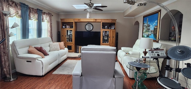 living room with hardwood / wood-style floors, crown molding, and ceiling fan