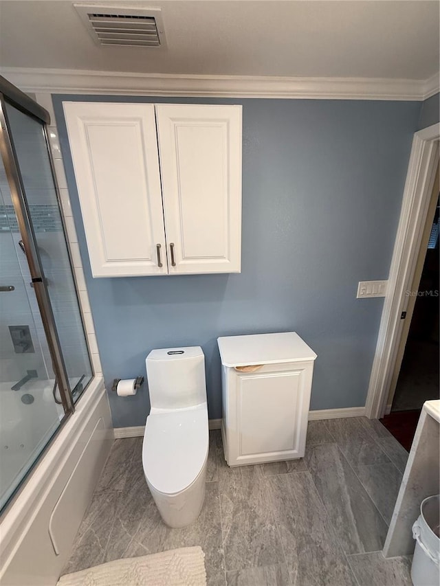 bathroom featuring bath / shower combo with glass door, toilet, baseboards, visible vents, and crown molding
