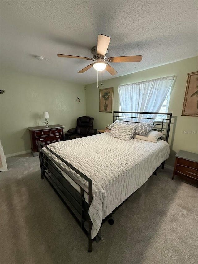 bedroom with baseboards, a ceiling fan, a textured ceiling, and carpet
