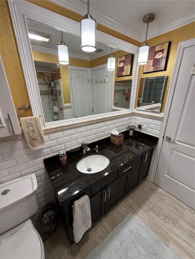 full bathroom featuring decorative backsplash, toilet, ornamental molding, and vanity