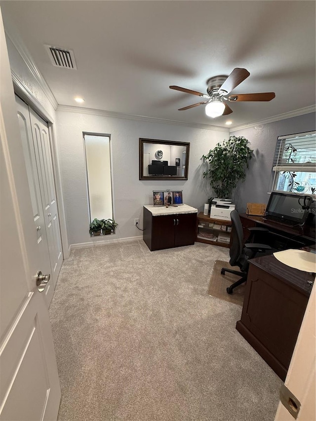 office featuring baseboards, visible vents, a ceiling fan, carpet floors, and ornamental molding