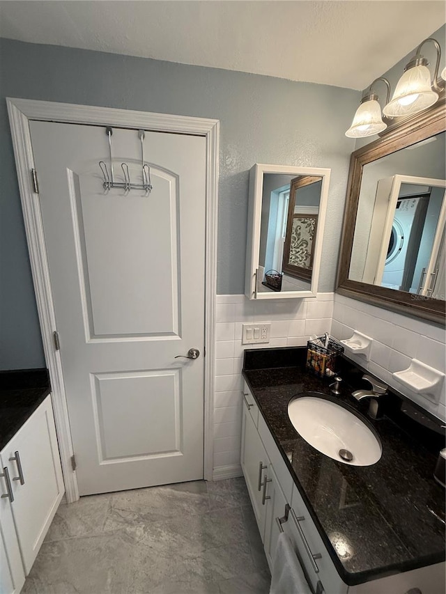 bathroom featuring tile walls, marble finish floor, and vanity