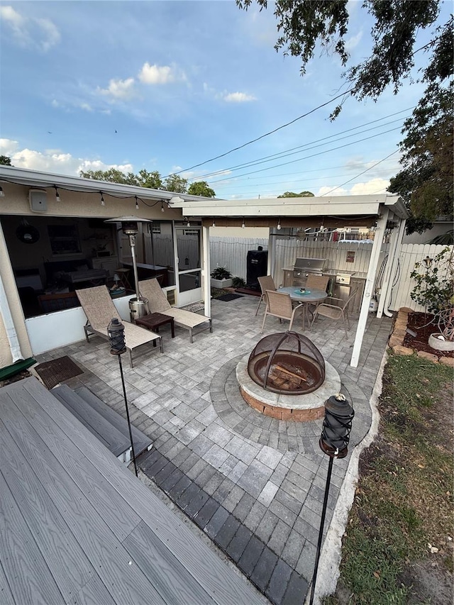view of patio / terrace featuring fence and an outdoor fire pit