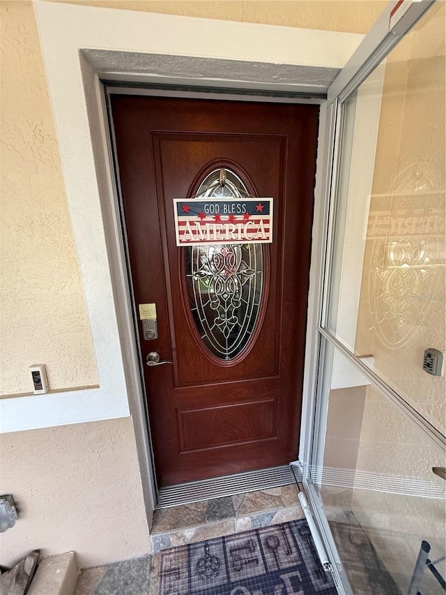 property entrance featuring stucco siding