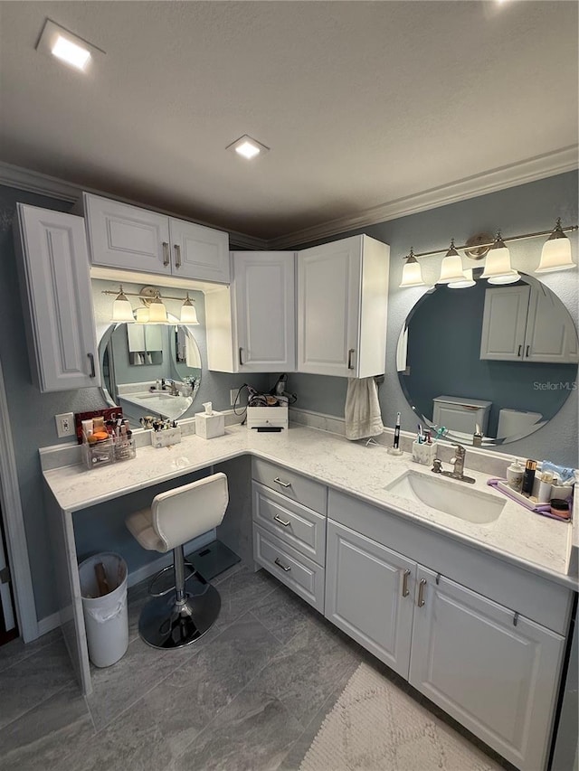 bathroom featuring vanity and ornamental molding
