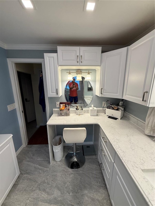 kitchen with white cabinets and crown molding