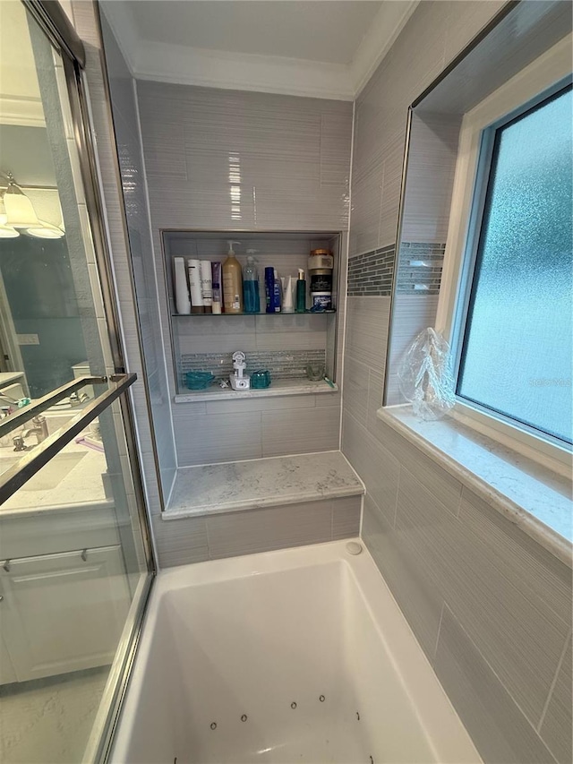 full bath with a whirlpool tub and ornamental molding