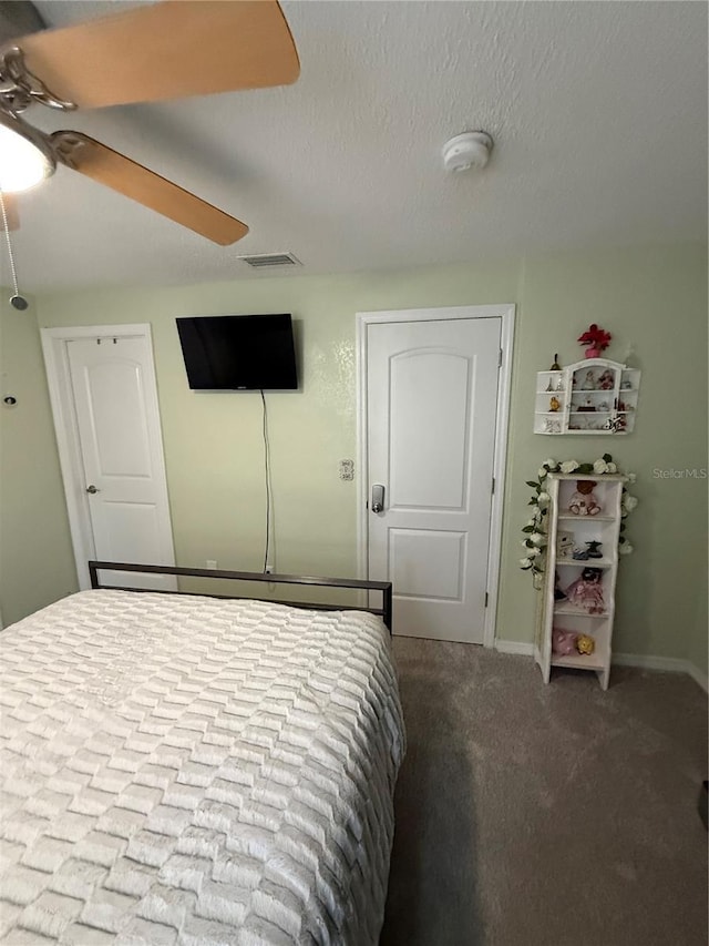 bedroom featuring baseboards, visible vents, carpet, and ceiling fan