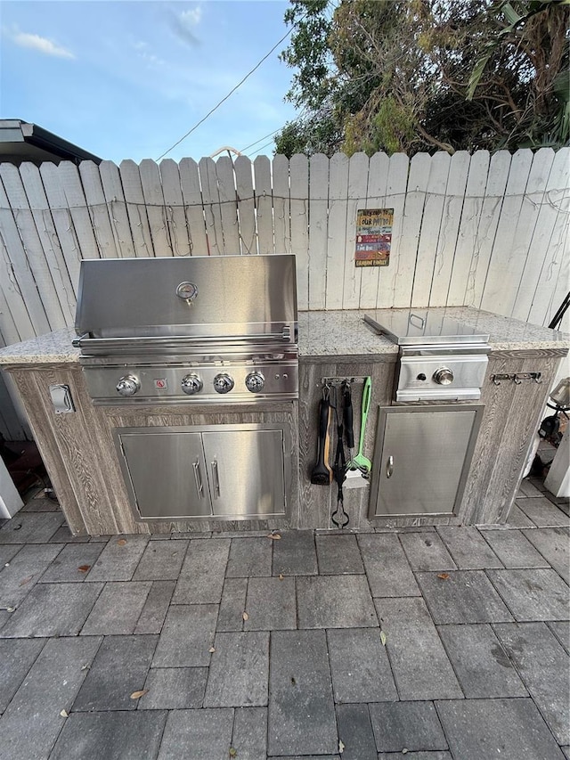 view of patio with an outdoor kitchen and area for grilling