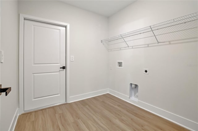 laundry area featuring laundry area, baseboards, light wood-style flooring, hookup for a washing machine, and hookup for an electric dryer