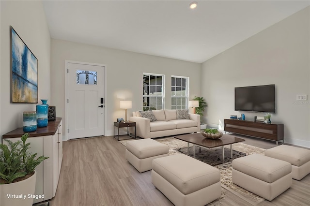 living area featuring light wood-type flooring and baseboards