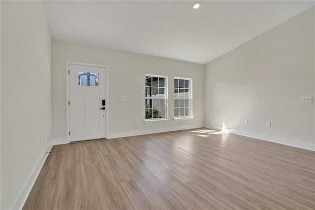 entrance foyer with light wood finished floors and baseboards