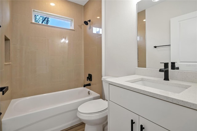 bathroom with vanity, toilet, and shower / bathtub combination