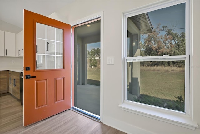 doorway with light wood finished floors