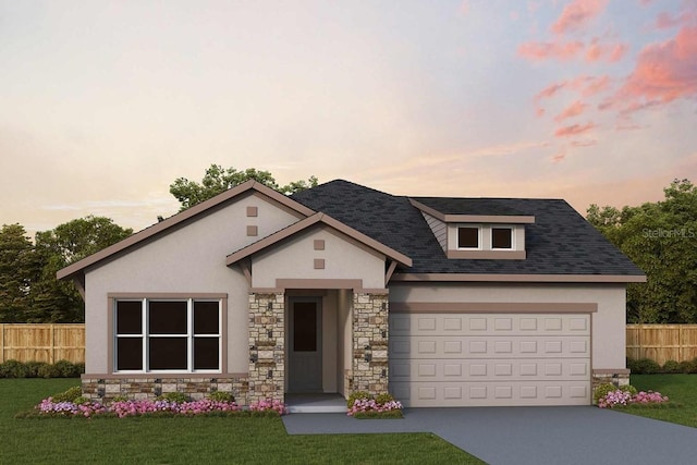 view of front of house featuring a garage and a yard