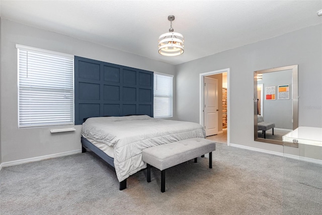 bedroom featuring light carpet and baseboards