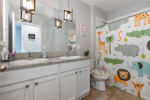 full bath featuring wood finished floors, a sink, toilet, and double vanity