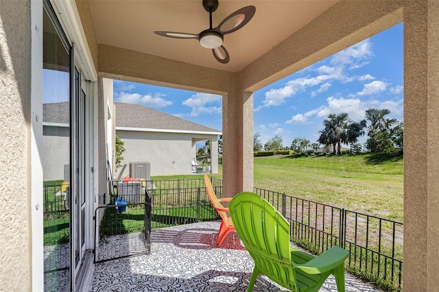 view of patio featuring a ceiling fan and fence