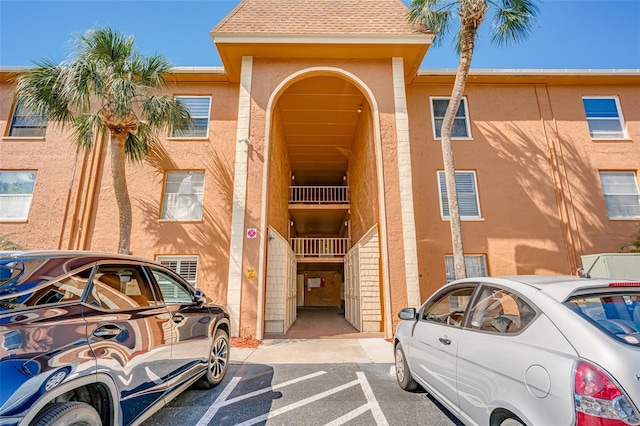 view of building exterior with uncovered parking