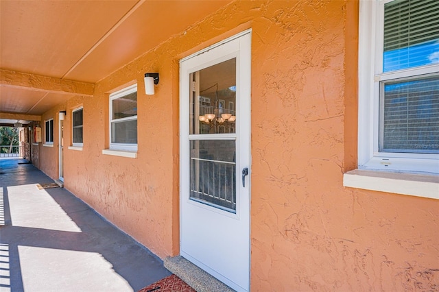 view of exterior entry with stucco siding