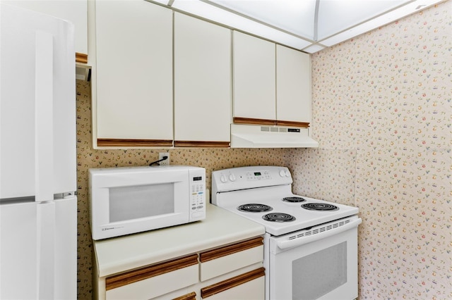 kitchen with light countertops, white appliances, white cabinets, and under cabinet range hood