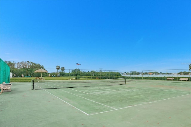 view of sport court featuring fence