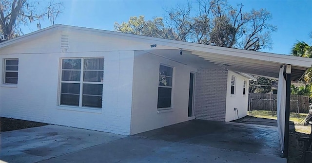 view of property exterior with a carport