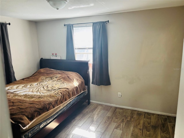 bedroom with wood-type flooring