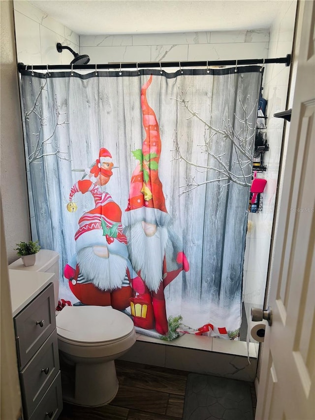 bathroom featuring hardwood / wood-style flooring, toilet, vanity, and a shower with shower curtain