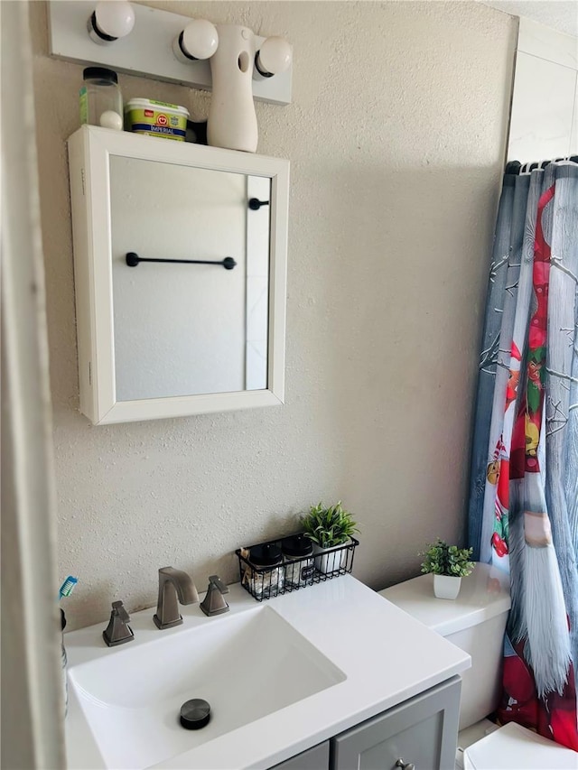 bathroom featuring toilet and vanity