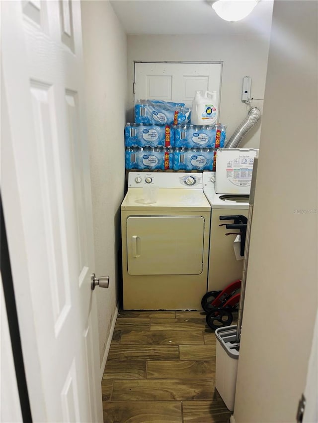 laundry room with washing machine and dryer and dark hardwood / wood-style floors